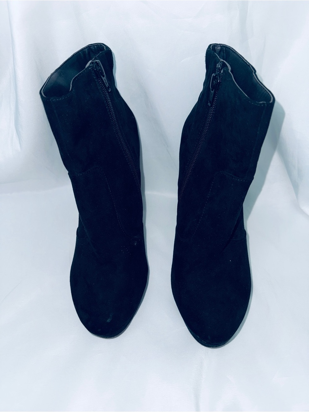 Woman’s black heeled zip up boots